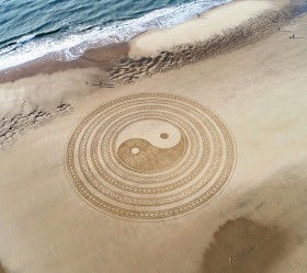 A giant Yin and Yang symbol on the beach